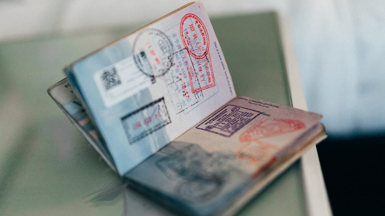 An open passport filled with entry and exit stamps